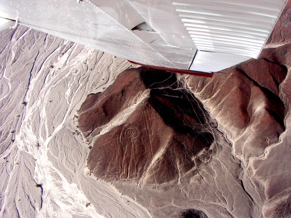 Guide assisting travelers before a Nazca Lines flight