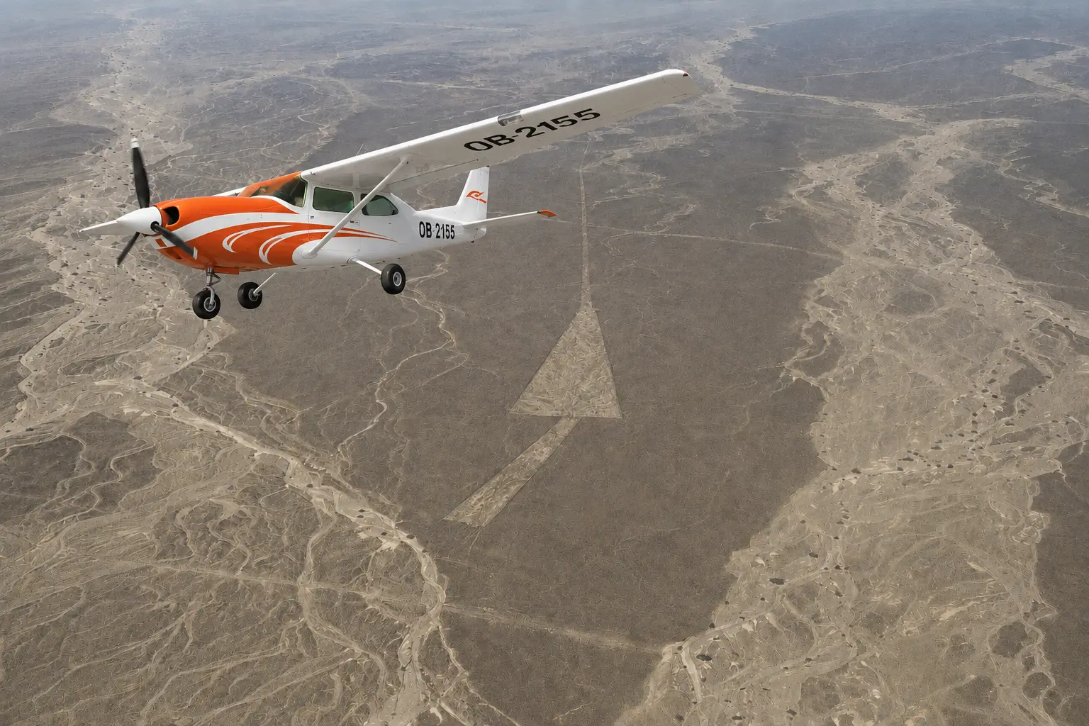 Small aircraft flying over the Nazca desert