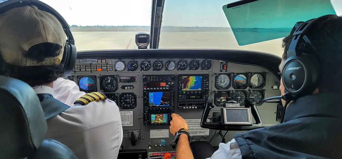 Pilots in the cockpit of a Cessna Grand Caravan before a Nazca Lines flight