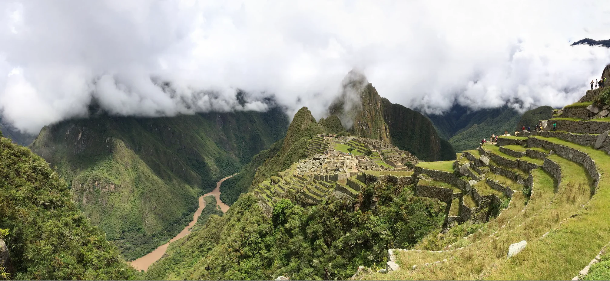 Machu Picchu terraces and mountains beneath low clouds